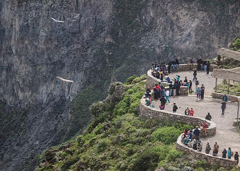 Visitors gathering at Cruz del Condor, a lookout point for spotting Andean condors in Colca Canyon.
