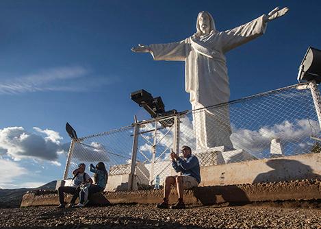 Visitors taking some photos at the Cristo Blanco statue, overlooking the city of Cusco.