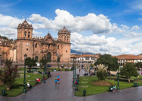 The Cusco Cathedral overlooking the Plaza de Armas (main square) on a partly cloudy day.