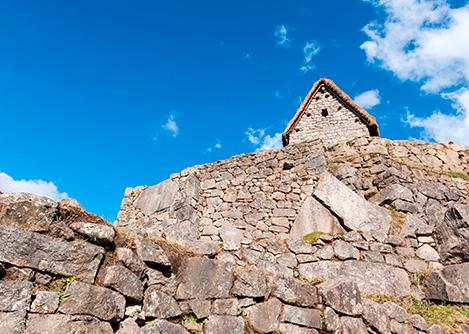 The guardhouse, a thatch-roofed stone building with a strategic view of Machu Picchu.