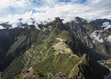 The Machu Picchu ruins as seen from Huayna Picchu, an emblematic mountain towering over the site.