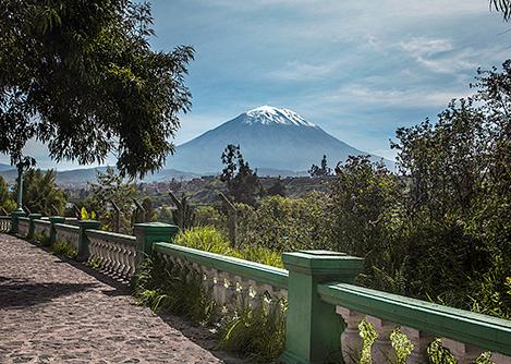 The iconic snow-capped Misti Volcano as seen from a cobblestone walkway in Arequipa.