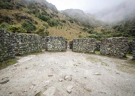 Mysterious stone walls forming a circle shape at Runkurakay, a site located on the Inca Trail.