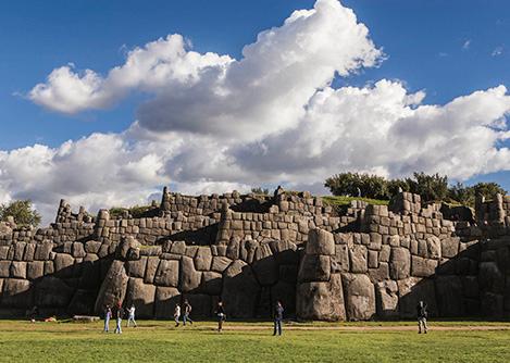 Visitors admire the massive stone walls of Sacsayhuamán, an impressive Inca fortress.