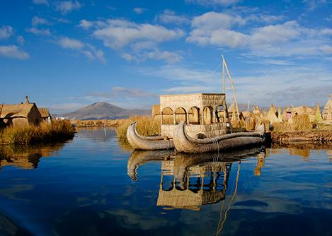 A totora reed boat next to the Uros Islands of Lake Titicaca, also constructed from totora reed