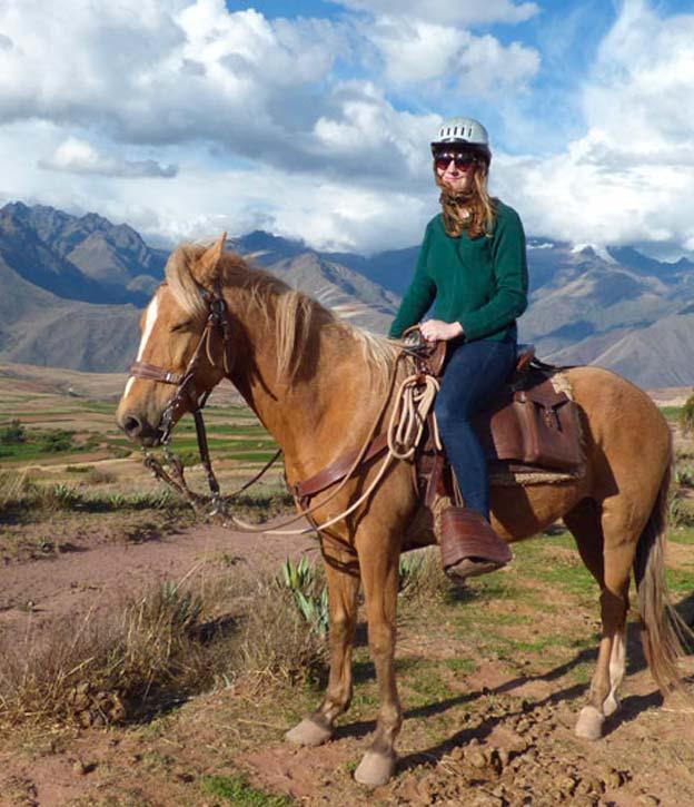 A visitor on horseback exploring the beautiful landscapes of Peru's Sacred Valley.