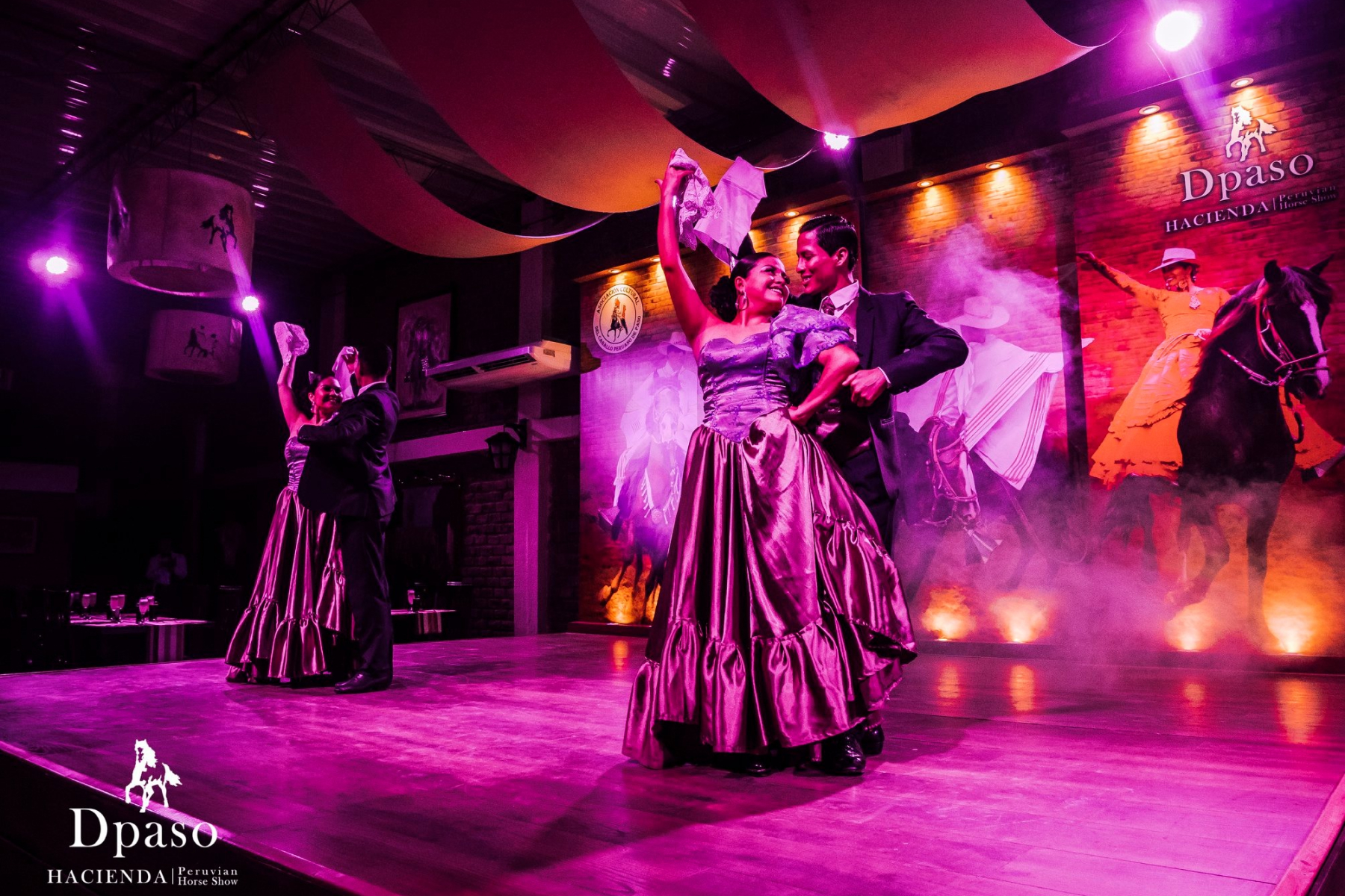 Two couples partaking in a traditional Peruvian dance.