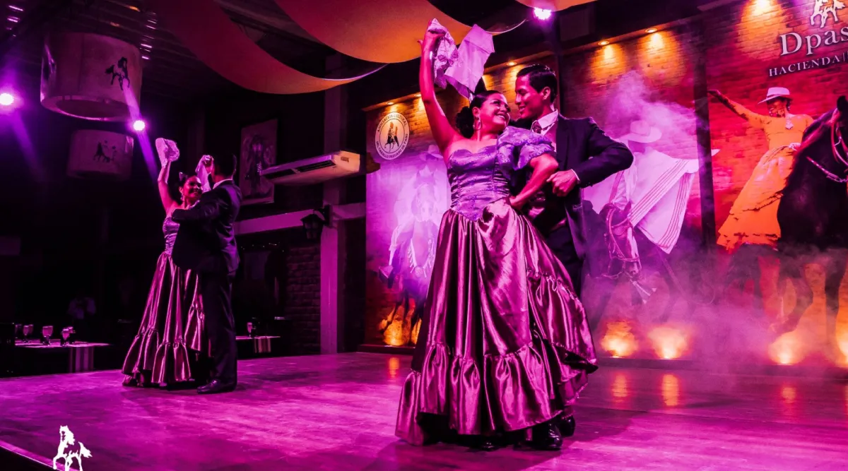 Two couples partaking in a traditional Peruvian dance.
