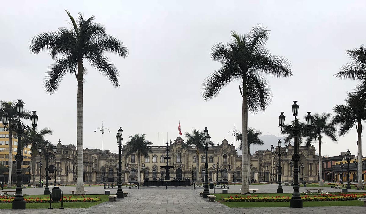 Lima's palm tree lined Plaza de Armas. The government palace is in the far background.