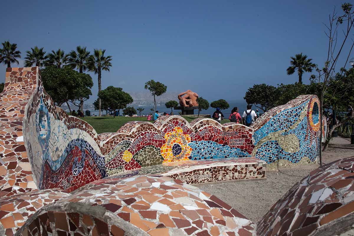 The colorful mosaic tiled walls at  Parque del Amor ("Love Park") with the famous Victor Delfín statue, El Beso ("The Kiss"), and Pacific Ocean in the background.