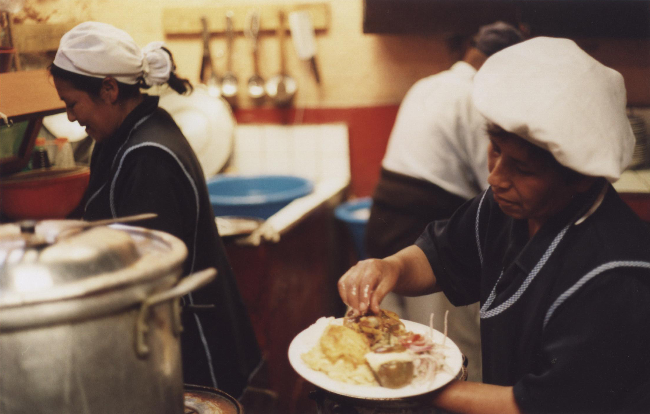 A picenteria cook adds the finishing touches on a plate at La Nueva Palomina in Arequipa.