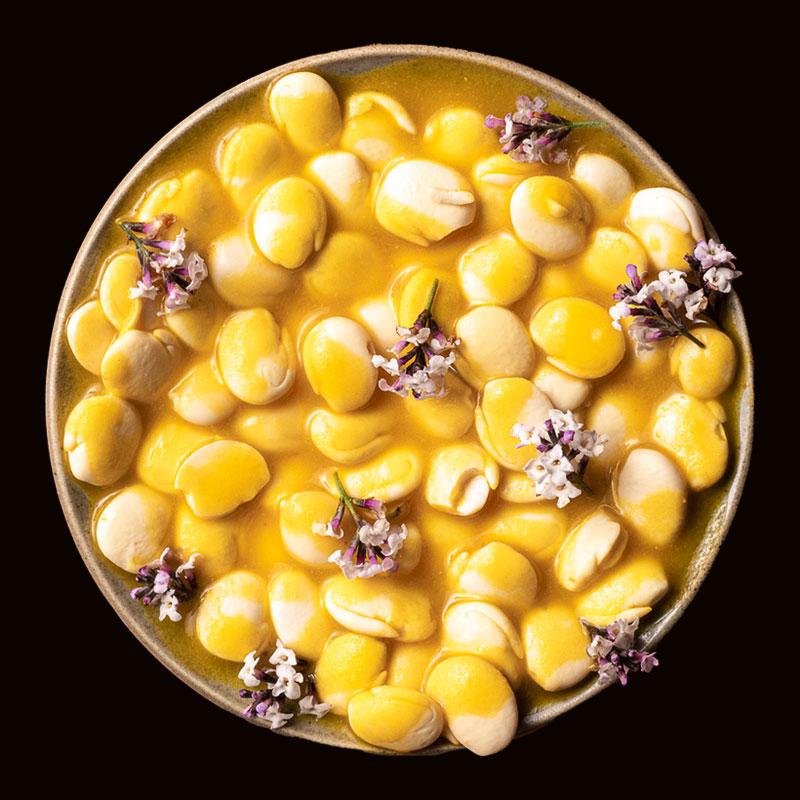 Tarwi, or lupini beans, served in a sauce with edible flowers at Mil Centro restaurant.