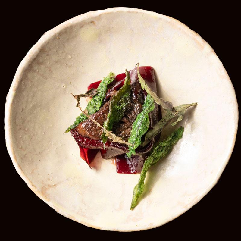 Exquisite presentation of a small dish with meat and some greens at Central restaurant.